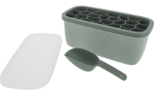 Grüner rechteckiger Behälter mit sechseckigen Mulden, daneben ein weißer rechteckiger Deckel und ein grüner Löffel