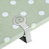 Clip en métal avec motif en spirale sur tissu vert clair à pois blancs à une bordure