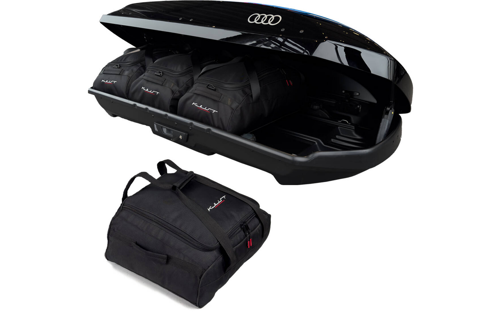 Offener schwarzer Dachkoffer mit Audi-Logo, drei schwarze Reisetaschen im Inneren und eine schwarze Tasche davor