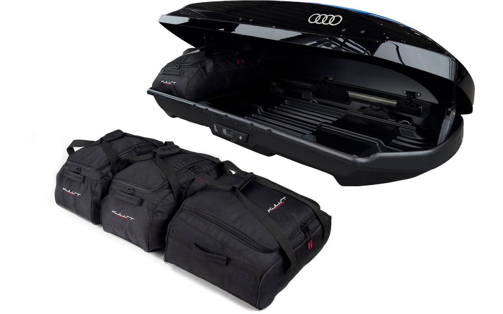 Geöffneter schwarzer Dachkoffer mit Audi-Logo, daneben vier schwarze Reisetaschen