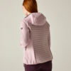 Person seen from back wearing a light pink hooded jacket with a horizontal quilted back panel and dark purple leggings; reddish hair visible
