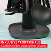 Gros plan d’un support noir avec des fentes, une cuillère noire et un bac égouttoir rectangulaire sur une surface turquoise ; bande rouge en bas avec texte blanc 'INKLUSIVE TROPF SCHALE Küchenhelfer abtropfen lassen'