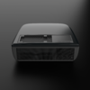 Black rounded rectangular device with ventilation grilles on top and front, small slider on top, on a dark background