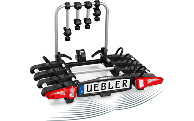 Schwarzer Fahrradträger mit silbernem Bügel, vier Haltearmen, roten Rücklichtern und weißem Nummernschild mit Aufschrift "UEBLER"