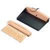 Small wooden hand brush with light bristles next to a black dustpan with wooden handle and hanging loop
