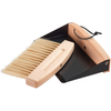 Hand brush with light wooden handle and light bristles beside a black metal dustpan with wooden front edge and hanging cord