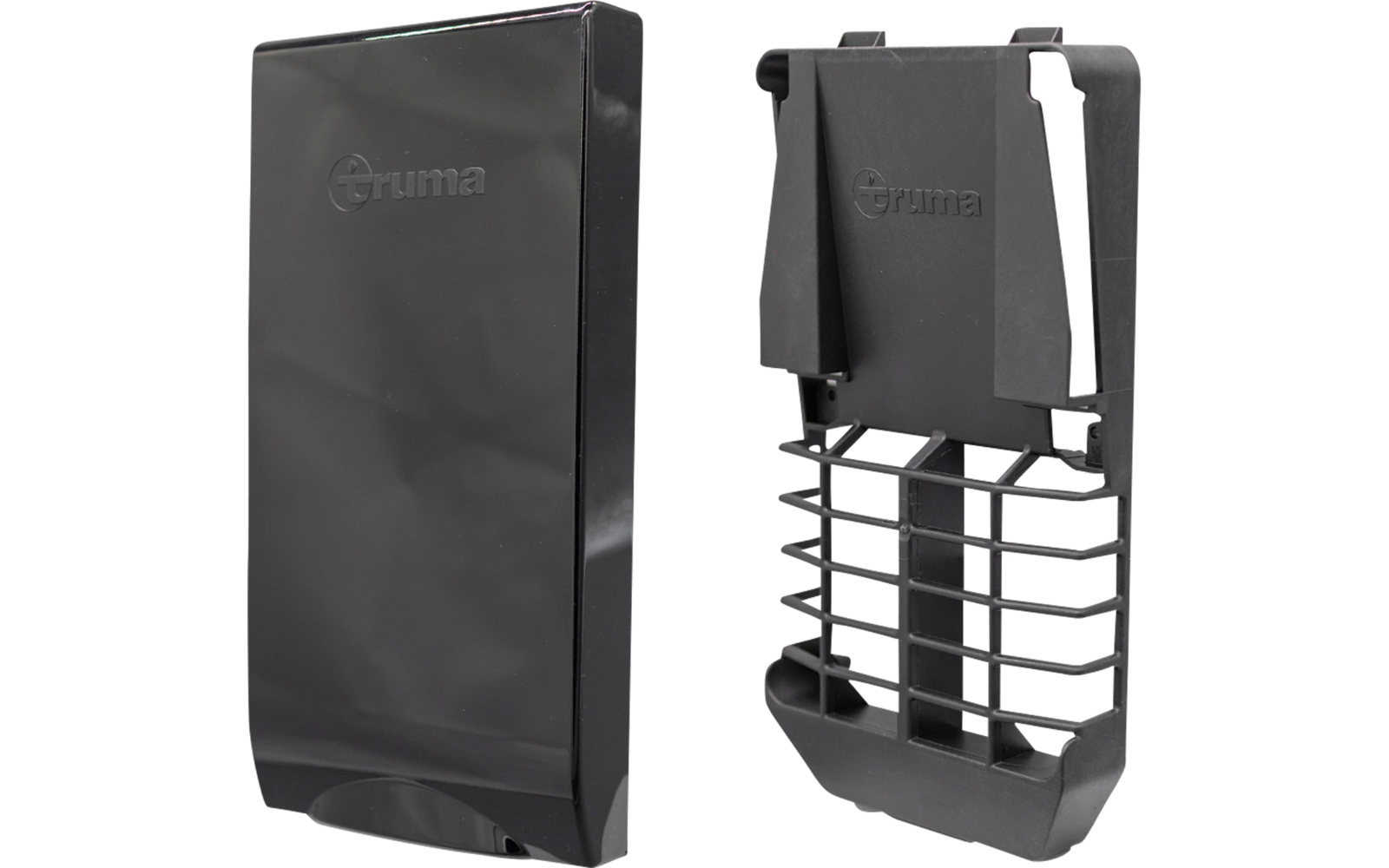Zwei schwarze Kunststoffteile nebeneinander: links eine glatte rechteckige Abdeckung mit geprägtem "Truma"-Logo, rechts eine offene Gehäusehälfte mit Gitterlüftung und Befestigungsbügeln