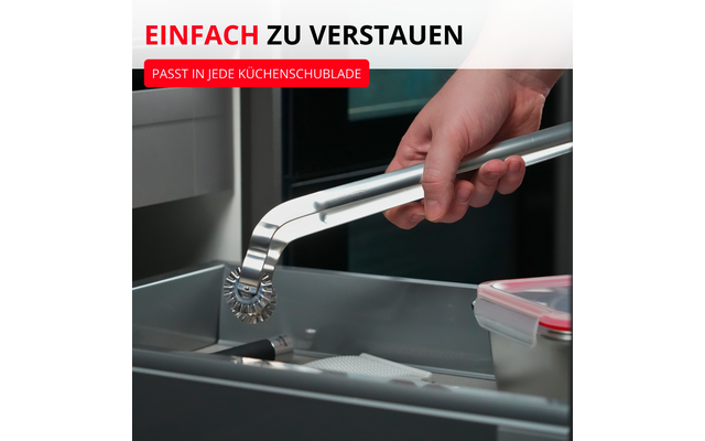 Main tenant un outil métallique argenté avec une roue dentée au‑dessus d'un tiroir de cuisine gris ouvert, à côté d'un récipient plastique transparent au couvercle rouge ; en haut à gauche texte rouge 'EINFACH ZU VERSTAUN' et label rouge 'PASST IN JEDE KÜCHENSCHUBLADE'