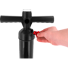 Hand holding a red valve/connector on the side of a black pump with a T-shaped handle and cylindrical body