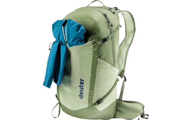 Hellgrüner Rucksack mit seitlicher Tasche, in der eine blaue Jacke steckt; auf der Tasche steht "deuter"; sichtbare Schultergurte, Hüftgurt und Reißverschlüsse