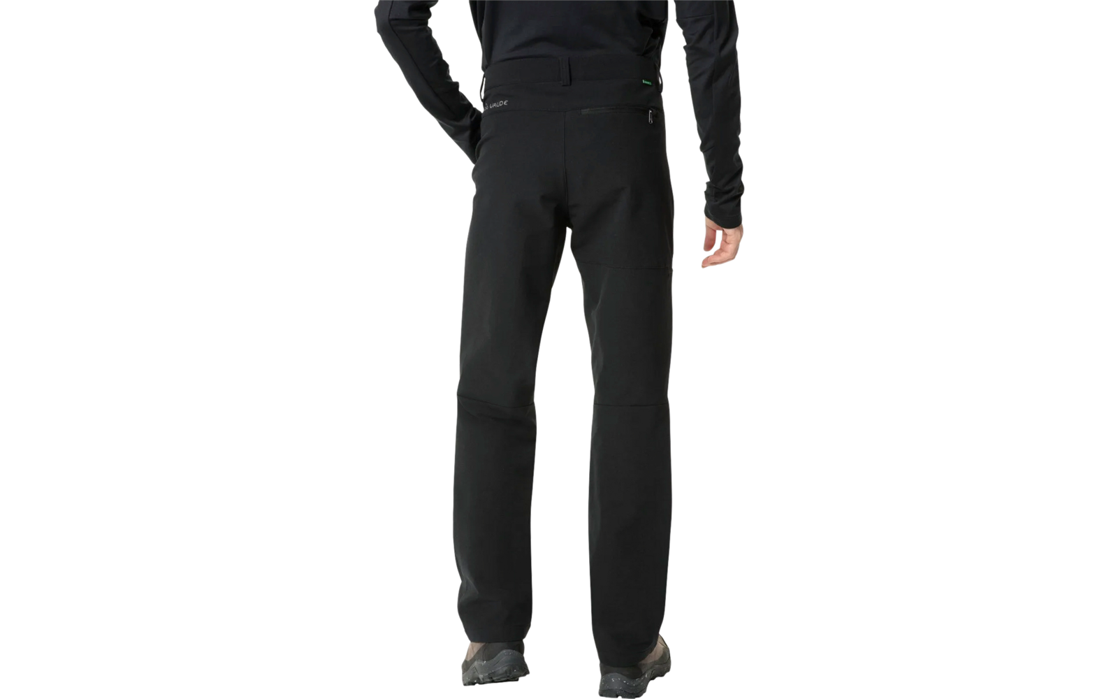 Person trägt schwarze Hose und schwarze Schuhe, nur Beine sichtbar