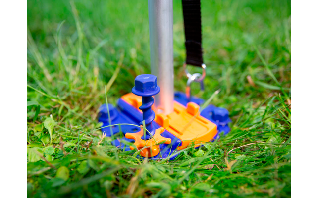 A blue and orange toy bird on the grass