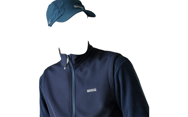 Man with short beard wearing a dark blue baseball cap and zip-up jacket with visible logo, looking right against a light background