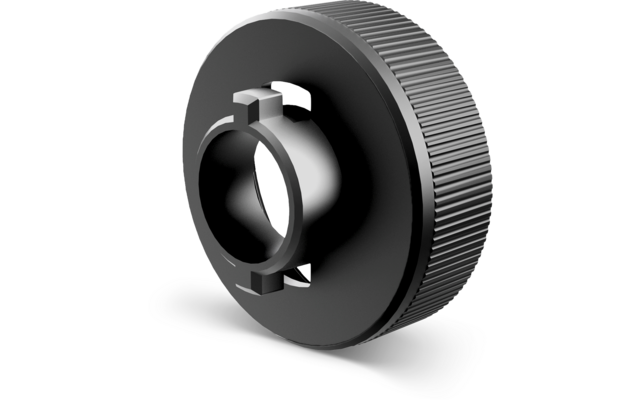 Élément circulaire gris foncé avec bord extérieur rainuré, moyeu central cylindrique surélevé, ouverture circulaire et quatre encoches rectangulaires