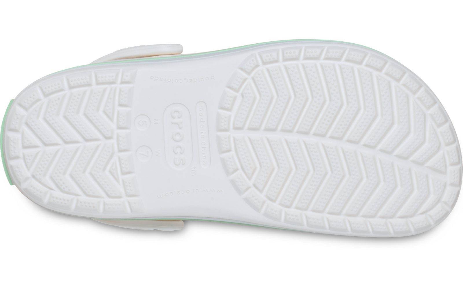 Onderzijde van een witte clogschoen met profiel en zijriem