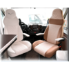 Two leather seats in a vehicle, one white and one beige, with armrests and dashboard in the background