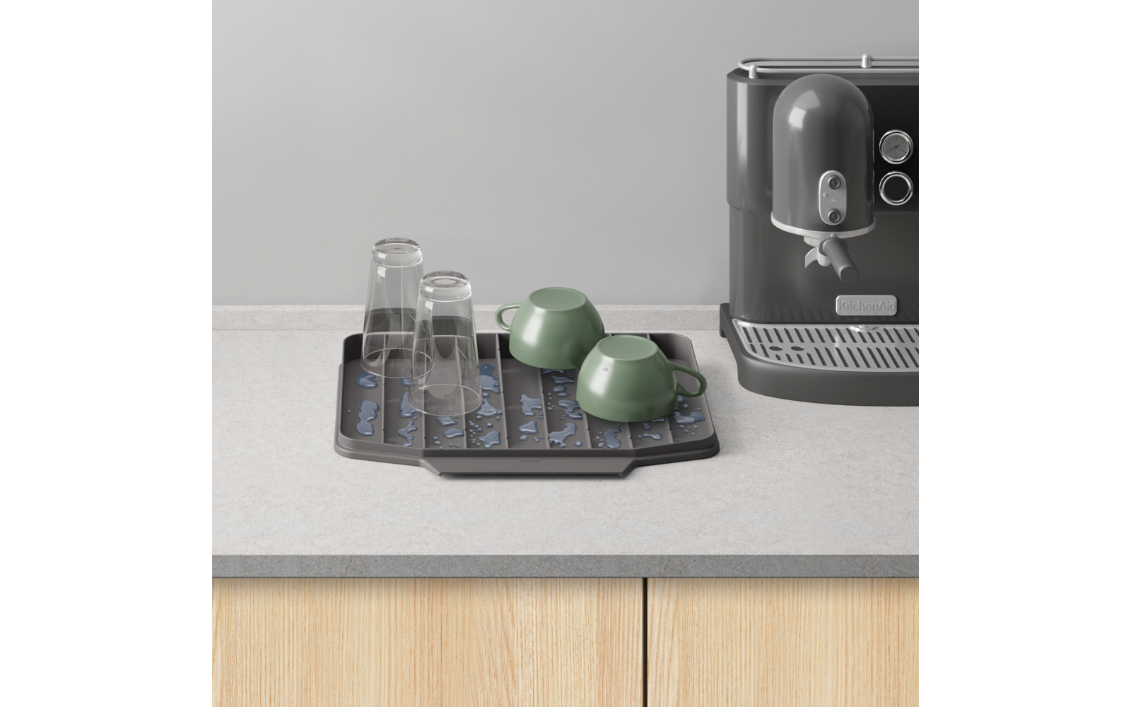 Capsules op tray naast espressomachine op keukenblad