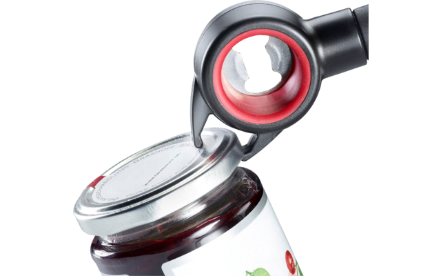 Poignée noire avec anneau de préhension rouge soulevant un couvercle argenté à vis ; bocal en verre avec contenu rouge et étiquette blanche