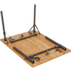 Underside of a rectangular wooden tabletop with folded gray metal legs, hinges, and brackets visible
