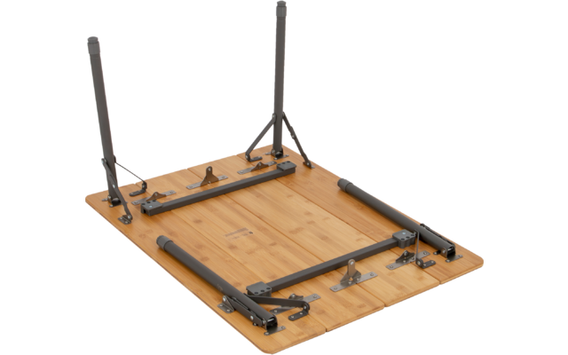 Underside of a rectangular wooden tabletop with folded gray metal legs, hinges, and brackets visible