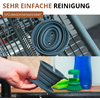 Image en deux parties : en haut un objet rond, gris et pliable en silicone sur une grille métallique ; en bas une main tient le même objet sous un jet d'eau du robinet, brosse verte et bouteille bleue en arrière-plan ; en haut le texte « SEHR EINFACHE REINIGUNG » et « SPÜLMASCHINENGEEIGNET »