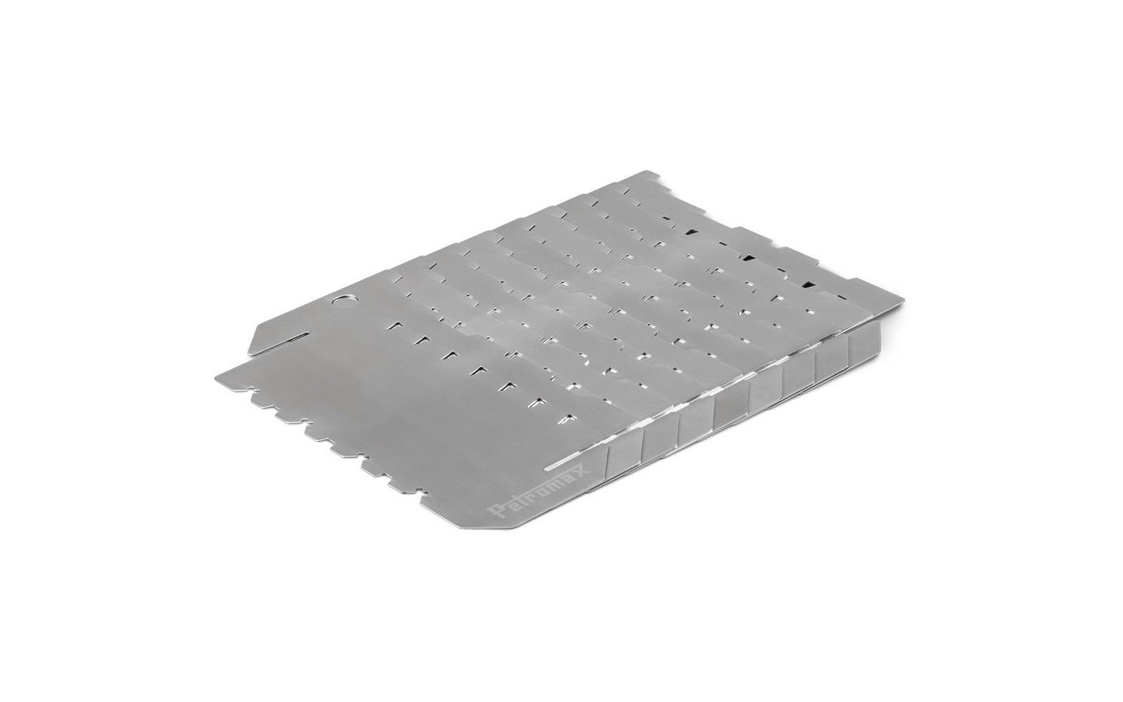 Silbernes rechteckiges Metallblech mit Reihen kleiner Schlitze und gefalteten Rippen an einer Kante, auf weißem Hintergrund