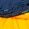 Folded dark blue fabric on yellow-orange fabric, the dark part shows the text 'TAMBU'