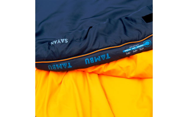 Folded dark blue fabric on yellow-orange fabric, the dark part shows the text 'TAMBU'
