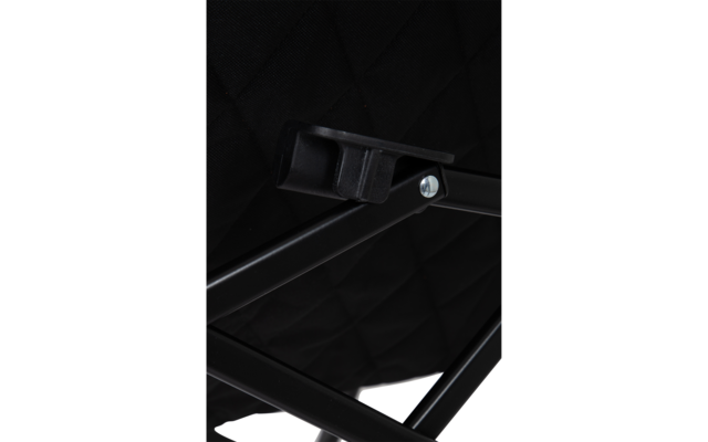 Close-up of a black metal frame with crossbars, a silver screw and a black plastic bracket against quilted black fabric
