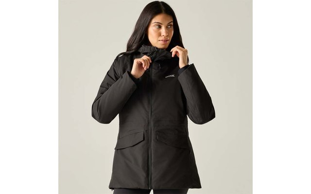 Person with long dark hair wearing a black parka, holding the collar with both hands; two front flap pockets, small chest logo, light background