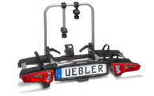 Metallrahmen mit zwei vertikalen Stangen, zwei roten Rücklichtern, Kunststoffhalterungen, Riemen und Nummernschild mit Aufschrift 'UEBLER'