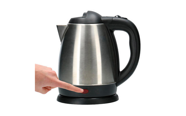Electric stainless steel kettle with black handle and base, a hand touching the base