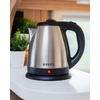 Electric stainless steel kettle on white countertop