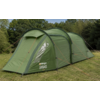 Green tunnel tent on a grassy field with guy lines and trees in the background