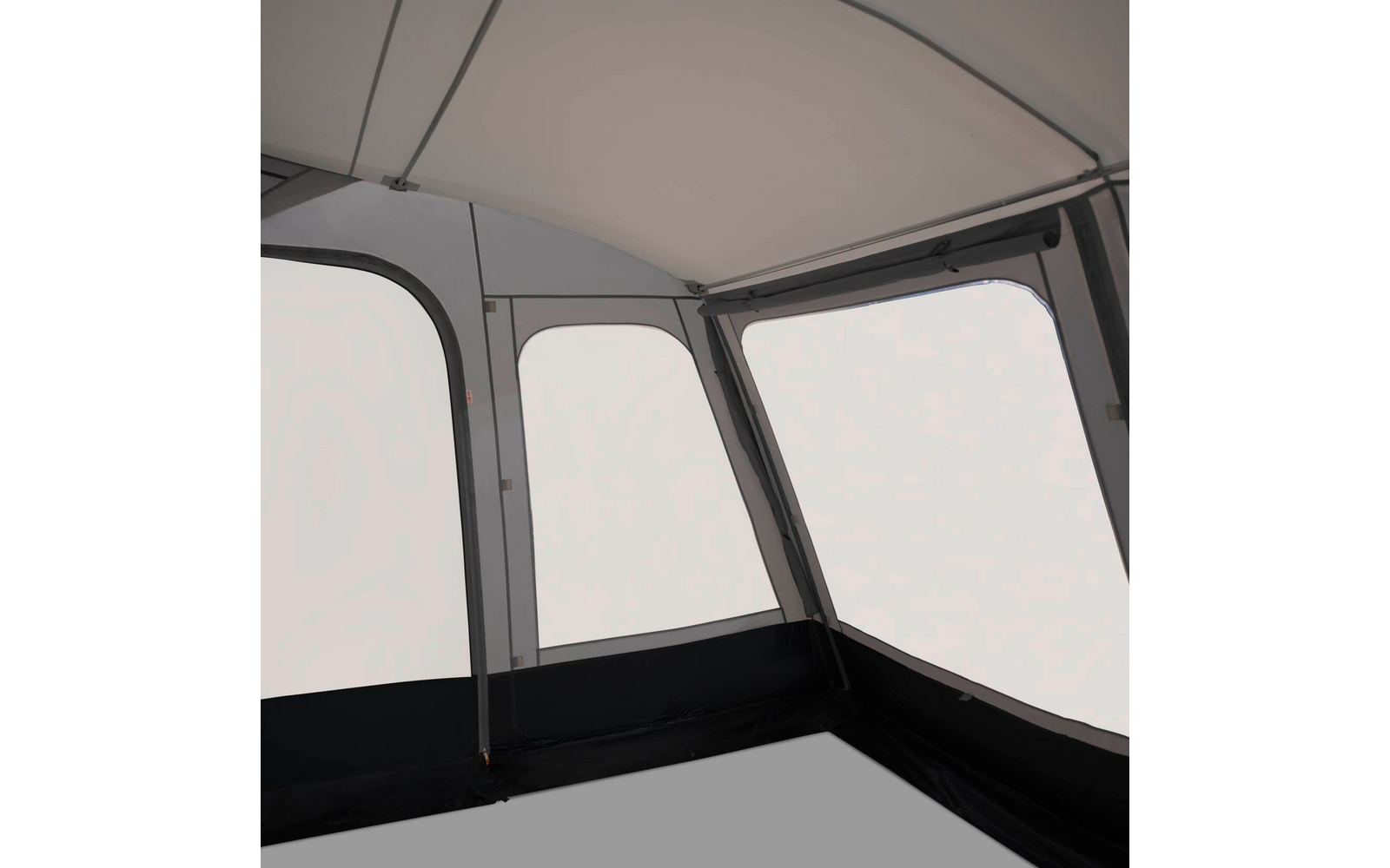Innenraum mit drei großen rechteckigen Fenstern, hellem Dach, grauen Wänden und schwarzem Unterrand