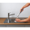 Hand vult glas met water uit keukenkraan