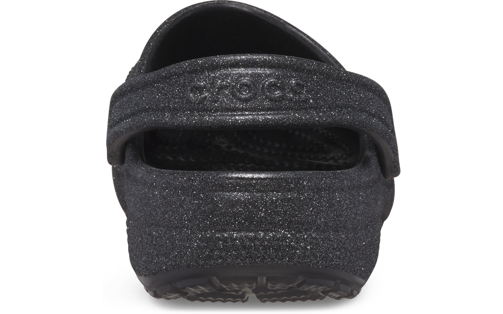 Vista trasera de un zueco negro con brillo y correa del talón levantada