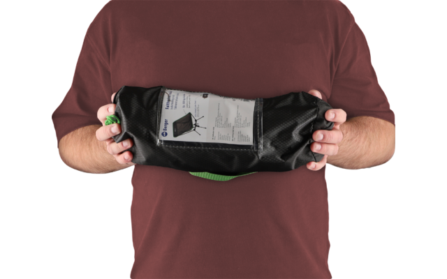 Person holding a black bag with visible contents in hands