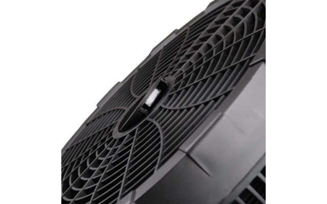 Nahaufnahme einer schwarzen Kunststoffscheibe mit radialem Gittermuster und zentraler kreisförmiger Öffnung