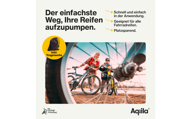 Pneu de vélo en train d'être gonflé avec une pompe, vélo posé sur un sol en planches de bois