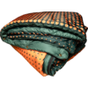 Folded quilted blanket in orange and dark green with a polka-dot pattern and visible snap buttons