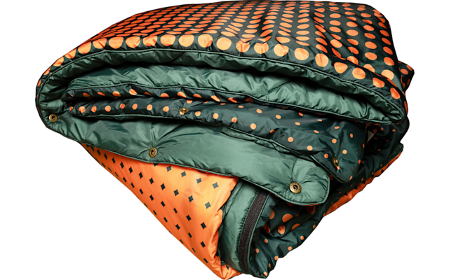 Folded quilted blanket in orange and dark green with a polka-dot pattern and visible snap buttons