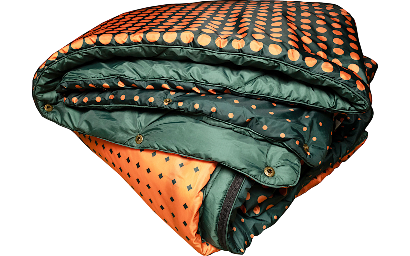 Folded quilted blanket in orange and dark green with a polka-dot pattern and visible snap buttons