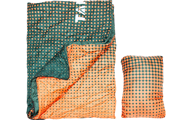 Open quilted rectangular textile in green with orange dots; inner side orange with a green repeating pattern; a folded matching textile beside it; white partial letters 'TA' visible