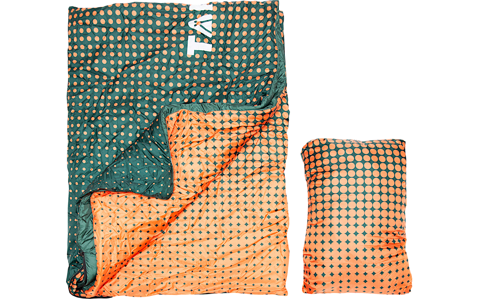Open quilted rectangular textile in green with orange dots; inner side orange with a green repeating pattern; a folded matching textile beside it; white partial letters 'TA' visible