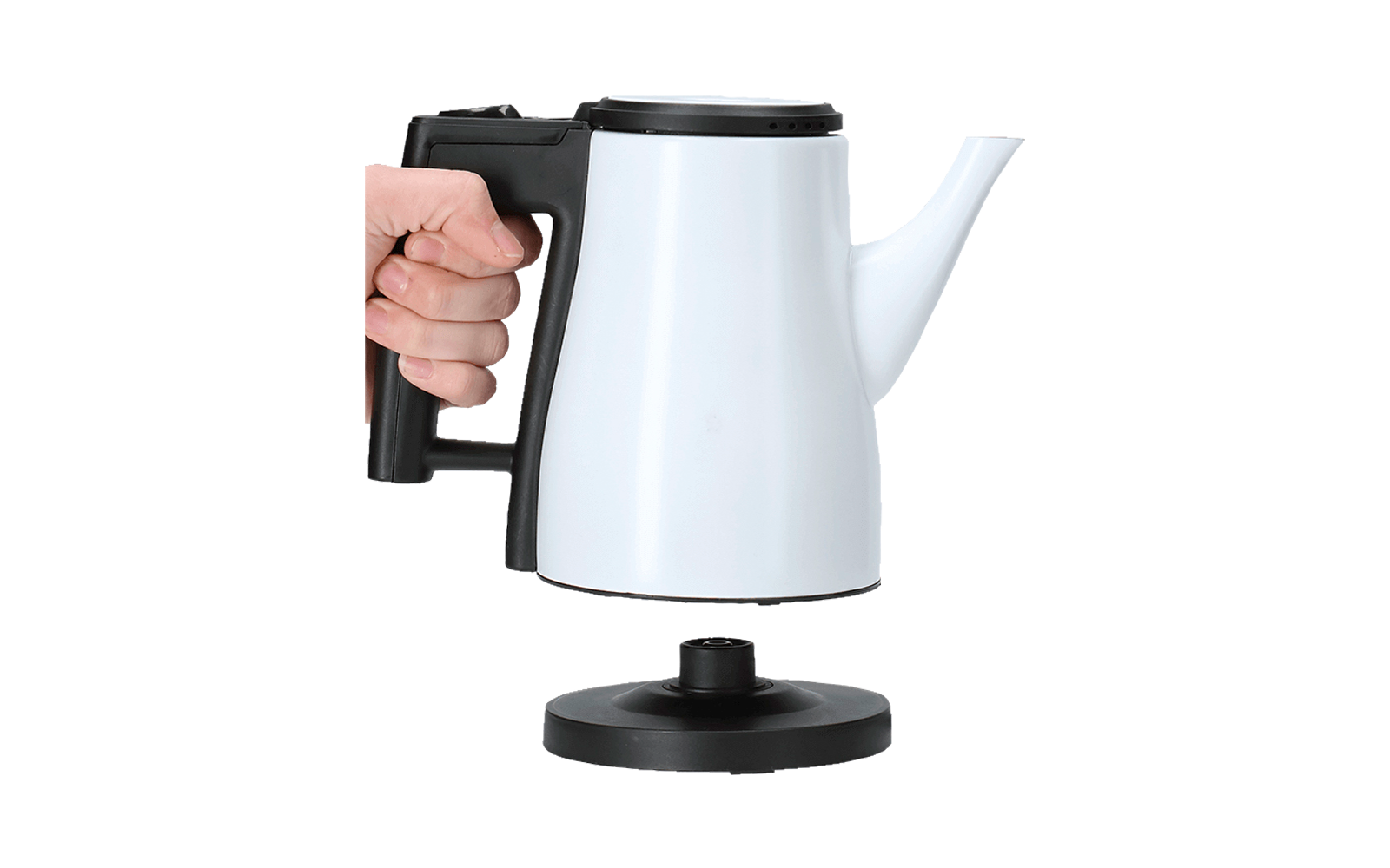 Hand holding white electric kettle with black handle over a round base