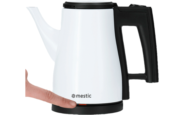 Electric kettle with long spout and black handle on black base, hand next to it
