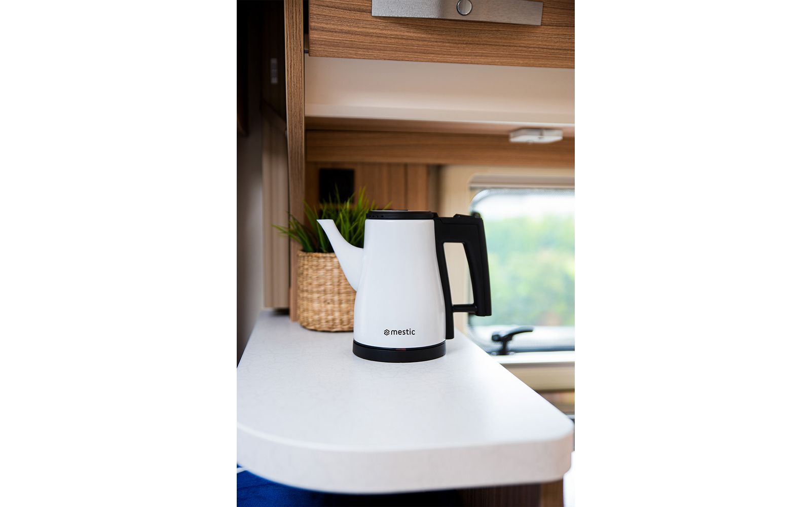 Electric kettle on a white countertop in a kitchen setting