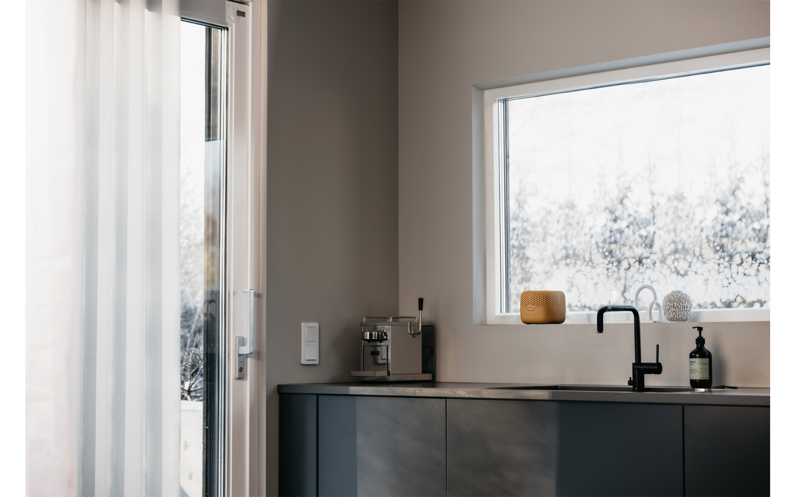 Küchenarbeitsfläche mit Wasserhahn und Fenster im Hintergrund