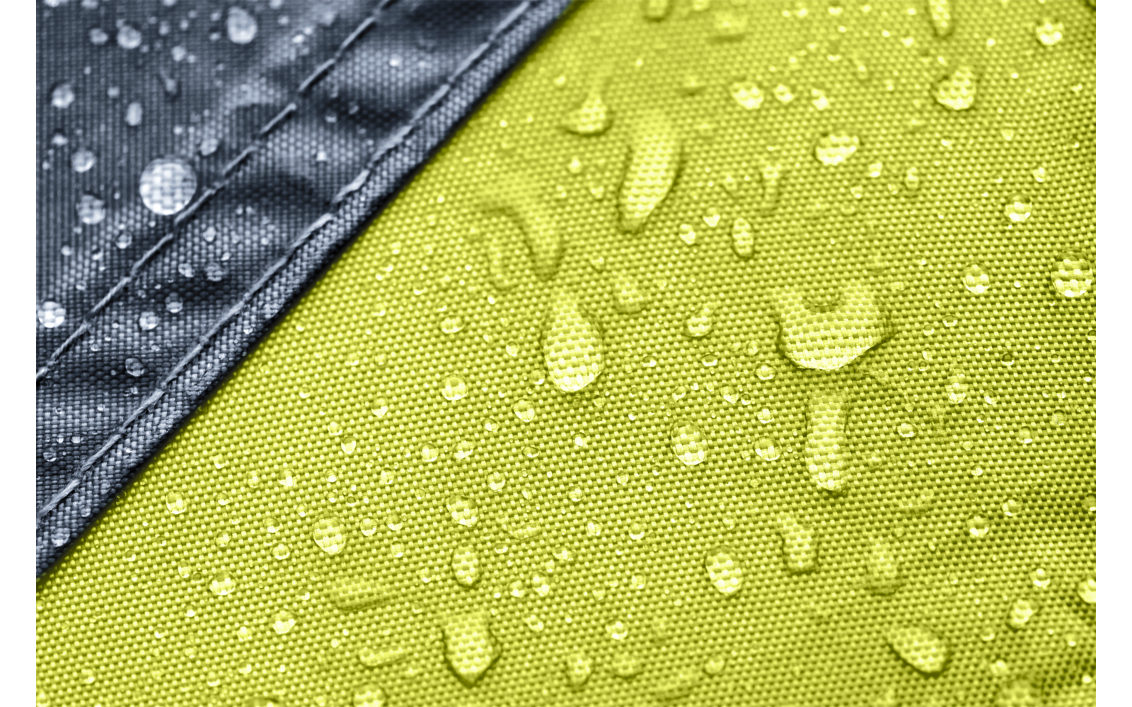 Green textured fabric with scattered water droplets and a diagonal gray fabric strip in the top left
